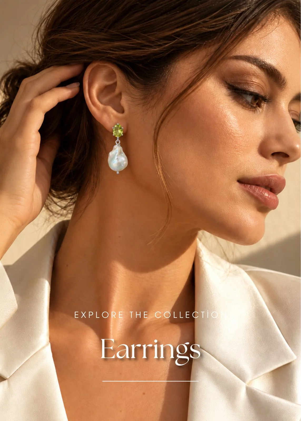 Woman wearing silver drop earrings with a green peridot stone and a large baroque pearl - Silverely earrings collection